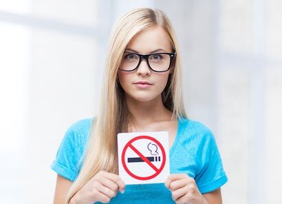 girl holding a no-smoking sign at the entrance. 